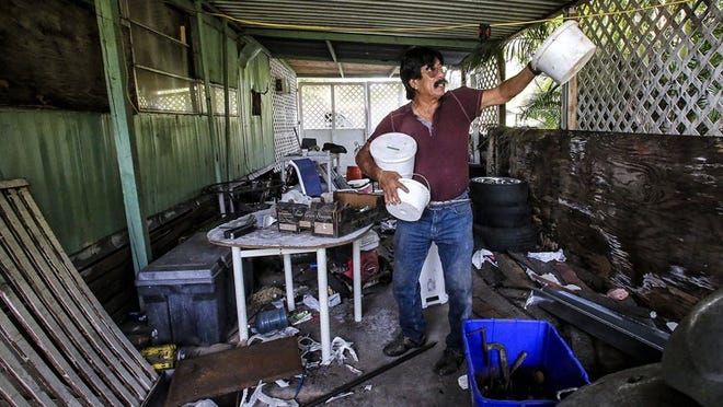 Early Tuesday morning, October 26, 2016 Domingo Galicia explains how a plane fell out of the sky last year and killed his daughter Banny, 21, while she was sleeping in her bedroom. Galicia who stopped by the mobile home for about 10 minutes to gather roofing supplies fought back tears as he said, “I asked her that morning if she was supposed to be in school. She said no, I’m tired. I need to sleep.” (Damon Higgins / The Palm Beach Post)