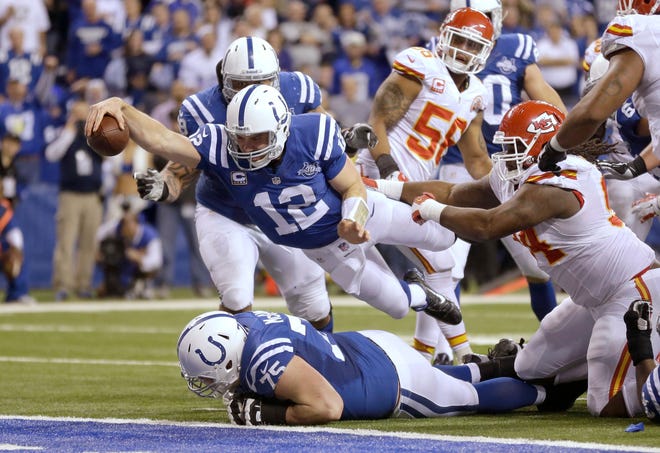 In this Jan. 4, 2014, file photo, Indianapolis Colts quarterback Andrew Luck (12) dives for a touchdown against the Kansas City Chiefs in Indianapolis. Luck (concussion) will miss his first game of the season. Scott Tolzien will make his first start. (AP Photo/Michael Conroy, File)