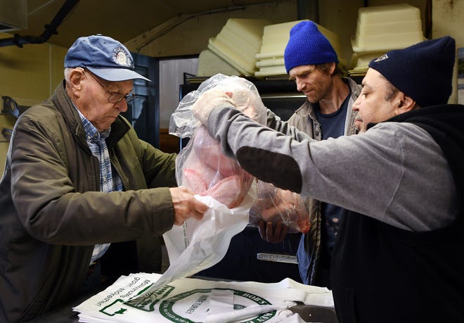 Bob Van Hoof, retired founder of Bob's Turkey Farm in Lancaster, packages Thanksgiving turkeys with workers Dave Zoll and Julio Ramos on Tuesday. T&G Staff/Rick Cinclair
