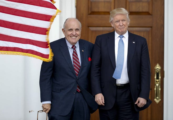 President-elect Donald Trump, right, and former New York Mayor Rudy Giuliani pose for photographs as Giuliani arrives at the Trump National Golf Club Bedminster clubhouse on Nov. 20, 2016, in Bedminster, N.J. Giuliani is reportedly on Trump's short list for secretary of state.