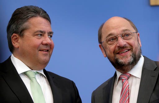 FILE - In this May 5, 2014 file photo German Sigmar Gabriel, chairman of the German Social Democratic Party, SPD, left, looks to German Martin Schulz, top candidate of the Party of European Socialists, PES, for the European elections and member of the board of the SPD prior to a press conference in Berlin, Germany. Germany's main center-left party faces pressure to decide on a challenger to Angela Merkel in next year's election.  (AP Photo/Michael Sohn, file)