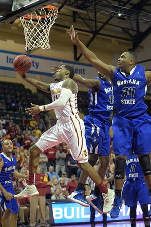 Iowa State guard Monte Morris (11) goes up for a shot in front of Indiana State forward Brandon Murphy (34) and center T.J. Bell (42) during the second half of an NCAA college basketball game at the AdvoCare Invitational tournament in Lake Buena Vista, Fla., Thursday, Nov. 24, 2016. Iowa State won 73-71. (AP Photo/Phelan M. Ebenhack)