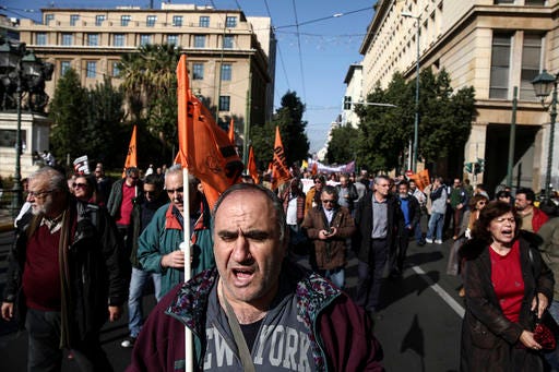 Workers of public sector chant slogans during a 24-hour strike in Athens, Thursday, Nov. 24, 2016. The country's largest civil servants union called a 24-hour strike for Thursday, arguing that mass staff cuts could not continue. Hundreds of protesters marched through the center of Athens in a peaceful demonstration. (AP Photo/Yorgos Karahalis)