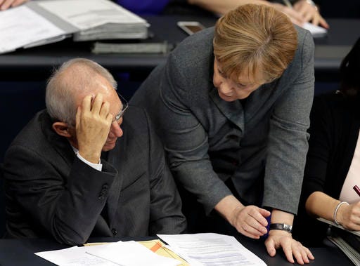 German Chancellor Angela Merkel, right, and German Finance Minister Wolfgang Schaeuble, left, talk during a budget debate as part of a meeting of the German Federal Parliament, Bundestag, at the Reichstag building in Berlin, Germany, Tuesday, Nov. 22, 2016. (AP Photo/Michael Sohn)