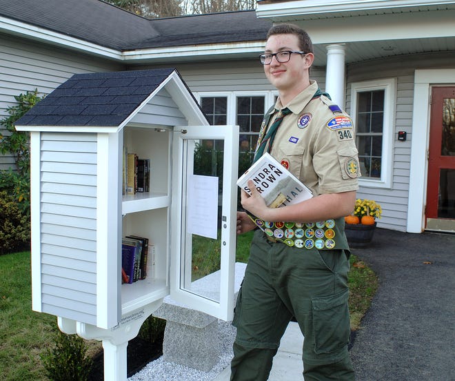 Boy Scout Paul Spezia of Troop 340 in Eliot, Maine, shows his Eagle Scout project, a Little Free Library, bench and landscaping in front of the town office. 

Photo by Ralph Morang