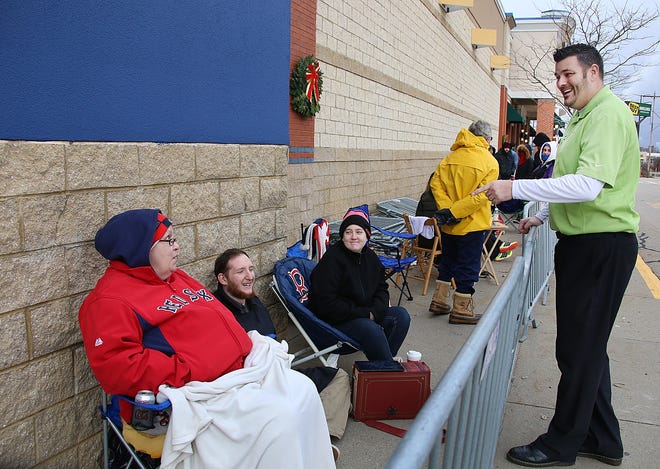 Michael Sargent, general manager at Best Buy in Newington, jokes around with customers Suzanne Marie of Hampton, at left, her granddaughter Katie Perry of South Hampton, and Katie's boyfriend Brendan Page of Kingston, while waiting for the doors to open for Black Friday sales on Thanksgiving Day.Photo by Rich Beauchesne/Seacoastonline