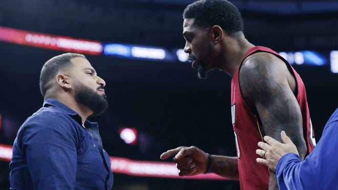 Miami Heat forward Udonis Haslem is separated from a fan who Haslem felt was taunting him during the second half of an NBA basketball game against the Detroit Pistons, Wednesday, Nov. 23, 2016 in Auburn Hills, Mich. (AP Photo/Carlos Osorio)