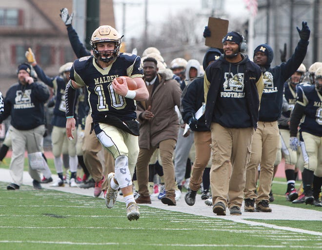 Malden's Jared Martino makes a run for the end zone for a touchdown during the 129th Malden/Medford Thanksgiving football game Thursday, Nov. 24, at MacDonald Stadium. Malden won the game 41-18. Photo by Nicole Goodhue Boyd