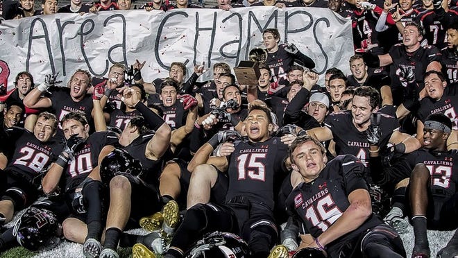 The Lake Travis Cavaliers celebrate after a 40-21 Class 6A Division I area playoff victory over the Smithson Valley Rangers Nov.18 at Bobcat Stadium in San Marcos. The win propels the Cavs into the third round of the state playoffs today at 1 p.m. at Cavalier Stadium.JOHN GUTIERREZ FOR LAKE TRAVIS VIEW