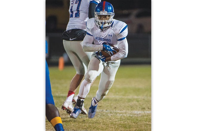 Asheboro's Desmond Trogdon runs the ball against Eastern Guilford during Friday's second round of the NCHSAA 3-AA playoffs at EGHS.