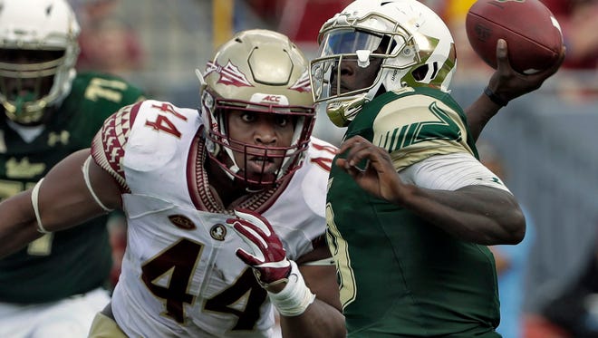 DeMarcus Walker (44) of Jacksonville leads the Florida State Seminoles against the Florida Gators on Saturday in Tallahassee. (AP Photo/Chris O’Meara)