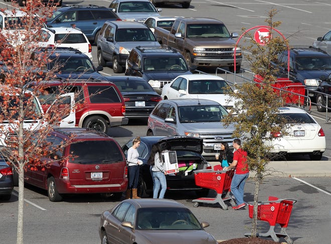 Target shoppers load items into their car in the parking lot Friday afternoon. Shoppers need be sure to keep items out of sight and lock there cars as car break-in numbers rise during the holiday shopping season. JOHN CLARK/THE GAZETTE