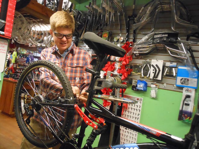 Ernie Lehman Jr. makes repairs on a bike earlier this week at Ernie's Bike Shop in Massillon. As a small business, the shop offers unique services such as ice-skate sharpening and live Christmas tree sales. (IndeOnline.com / Steven M. Grazier)
