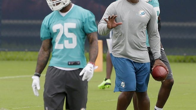 Miami Dolphins defensive coordinator Vance Joseph gives instructions as cornerback Xavien Howard (25) practices at the team's NFL football training facility, Monday, June 6, 2016, in Davie, Fla. As Joseph began to evaluate the Dolphins’ front four, linebackers and secondary in offseason drills, he felt a little uncomfortable with his own position. The first-time defensive coordinator was unsure about how to situate himself or spend his time. (AP Photo/Alan Diaz)