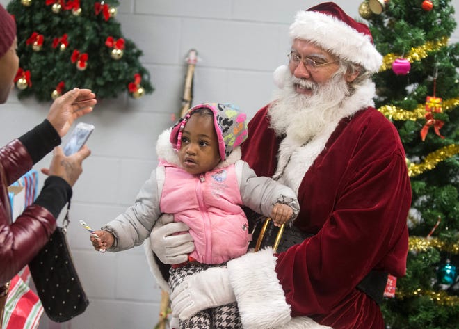 Andrea Hester sits on Santa's lap during the annual Empty Stocking event on Dec. 12, 2015, at the Rockford Register Star. RRSTAR.COM FILE PHOTO