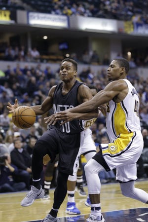 Nets guard Yogi Ferrell, left, is fouled by Pacers guard Glenn Robinson III during the second half of Friday night's game in Indianapolis. The Associated Press