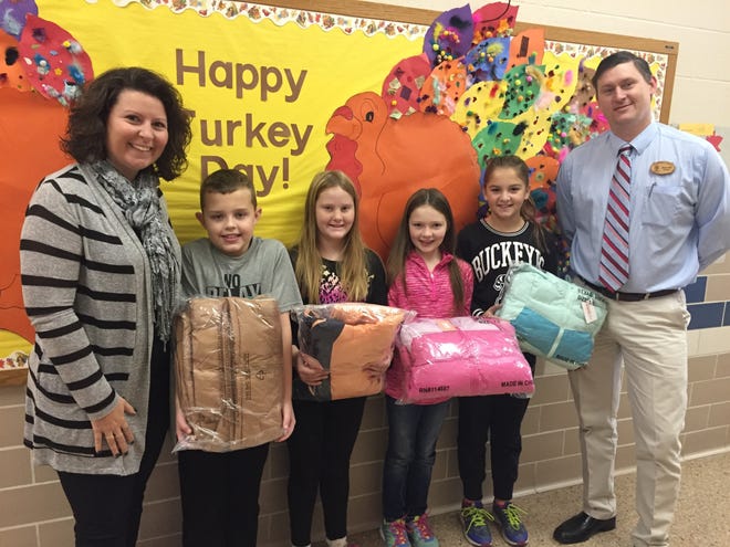 The Rotary Club of Dover plans to give almost $1,000 worth of new winter coats for children during the holiday season. Pictured, from left: Dover East Elementary Principal Brooke Grafe; students Evan Stein, Abby Ice, Ella Mallernee and Gabi Marraccini; and rotary President Jim Gill. PHOTO PROVIDED