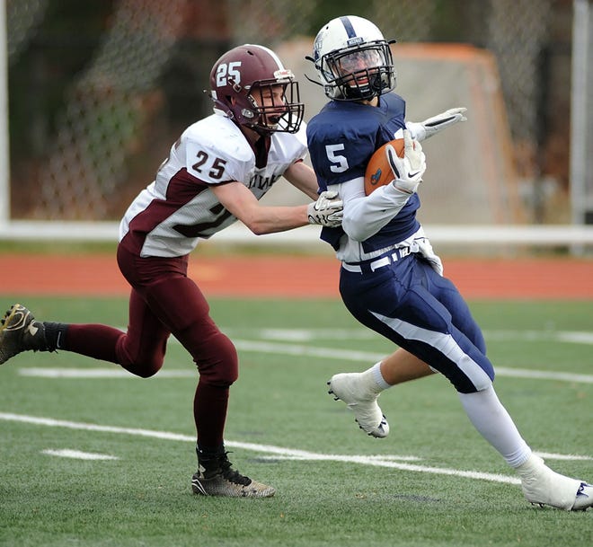 Millis-Hopedale's Tim Petipas attempts to tackle Medway's Patrick Travers during the Thanksgiving game in Medway. DAILY NEWS PHOTO/ALLAN JUNG