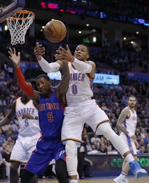 Detroit Pistons guard Kentavious Caldwell-Pope (5) and Oklahoma City Thunder guard Russell Westbrook (0) go after the ball during the first half of an NBA basketball game in Oklahoma City, Saturday, Nov. 26, 2016. (AP Photo/Alonzo Adams)