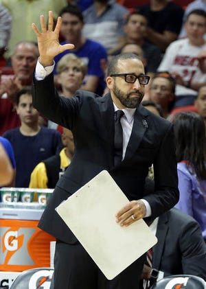 Memphis Grizzlies head coach David Fizdale waves as he is introduced before an NBA basketball game against the Miami Heat, Saturday, Nov. 26, 2016, in Miami. Fizzle was formerly an assistant coach with the Miami Heat. (AP Photo/Lynne Sladky)