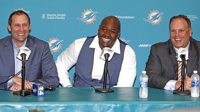 Miami Dolphins head coach Adam Gase and Executive Vice President of Football Operations Mike Tannenbaum with first-round draft pick Laremy Tunsil at the team's training facilty in Davie, Fla., on Friday, April 29, 2016. (Charles Trainor Jr./Miami Herald/TNS)