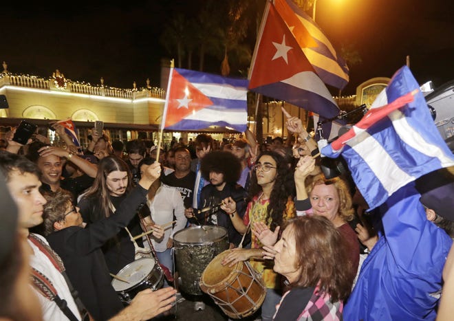 Cuban-Americans celebrate the death of Fidel Castro, Saturday, Nov. 26, 2016, in the Little Havana area in Miami. Castro died eight years after ill health forced him to formally hand power over to his younger brother Raul, who announced his death late Friday, Nov. 25, on state television. (AP Photo/Alan Diaz)