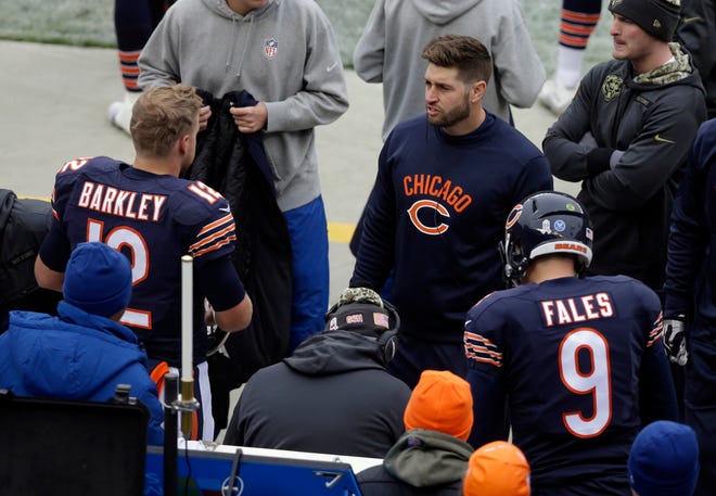 Chicago Bears' Jay Cutler talks to quarterback Matt Barkley (12) on the bench during the first half of an NFL football game against the Tennessee Titans, Sunday, Nov. 27, 2016, in Chicago. (AP Photo/Kiichiro Sato)