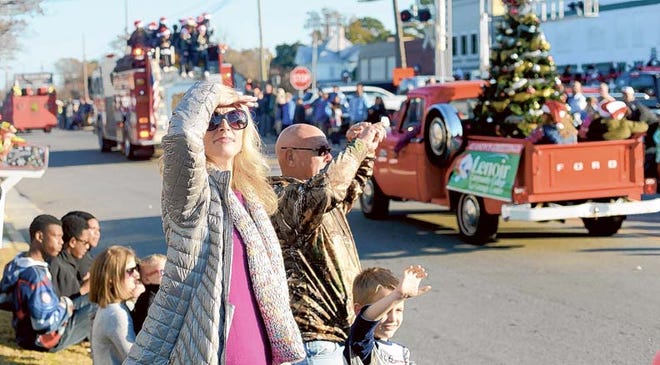 Jaime Moore and Aiden Skoczylas, 8, watch the La Grange Christmas parade Sunday from Caswell Street.
