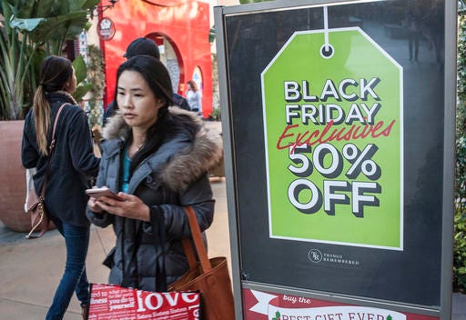 Shoppers look for deals at the Irvine Spectrum Center in Irvine, Calif., on Black Friday, Nov. 25, 2016. Stores are trying to better cater to savvier shoppers, who are splitting their spending back and forth online and in stores. That was apparent on Black Friday, the day after Thanksgiving, as shoppers were careful about what deals they'd jump at and retailers pushed different ways to connect with customers. (Nick Agro/The Orange County Register via AP)