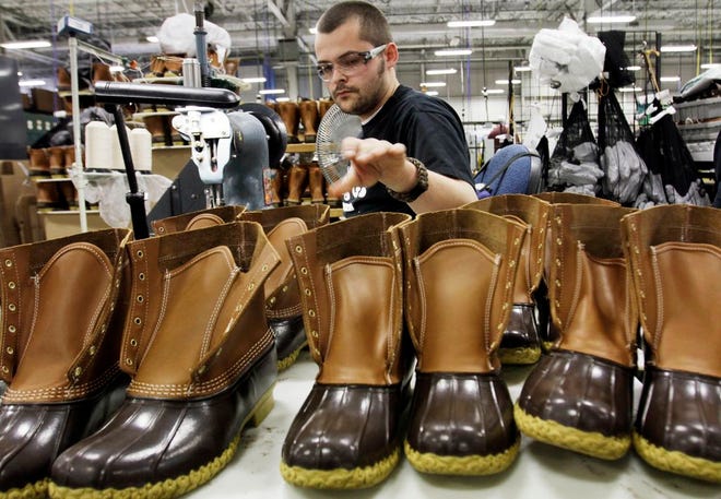 In this Dec. 14, 2011, file photo, Eric Rego stitches boots in the facility where LL Bean boots are assembled in Brunswick, Maine. L.L. Bean is kicking it up a notch as demand continues to surge for its iconic boot. The Maine-based outdoors retailer has leased a 110,000-square-foot building and plans to install a third injection-molding machine. The company is boosting production to meet demand that's expected to reach 1 million pairs in 2018. (AP Photo/Pat Wellenbach, File)