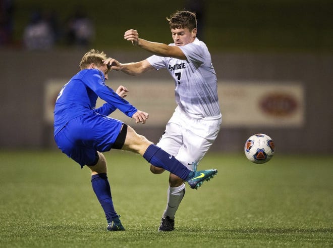Creighton's Luke Haakenson kicks the ball away from Providence's Steven Kilday during Saturday night's NCAA men's soccer tournament game in Omaha, Neb. The Friars won, 2-1, and will meet North Carolina on Friday.