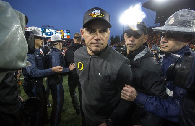 Oregon coach Mark Helfrich leaves the field after the Ducks' 34-24 loss to the Oregon State Beavers the 120th Civil War game at Reser Stadium in Corvallis. The Ducks finished the season 4-8. (Andy Nelson/The Register-Guard)