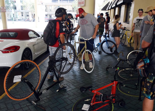 Around 30 bicyclists competed in Sol's Deli-Cat bike-messenger competition Sunday in Sarasota. The cyclists planned their own way to six locations, collected signatures from race officials and returned to Sol's NYC Deli on Main Street. HERALD-TRIBUNE STAFF PHOTO / CARLOS R. MUNOZ