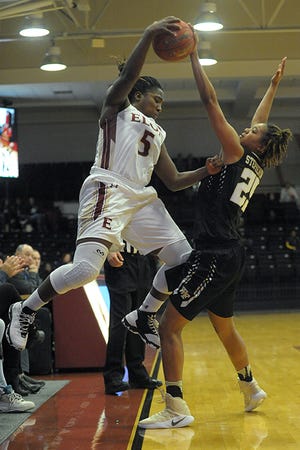Elon's Shaylen Burnett, left, tangles Wake Forest's Ariel Stephenson while trying to make a save on the sideline Saturday at Alumni Gym.