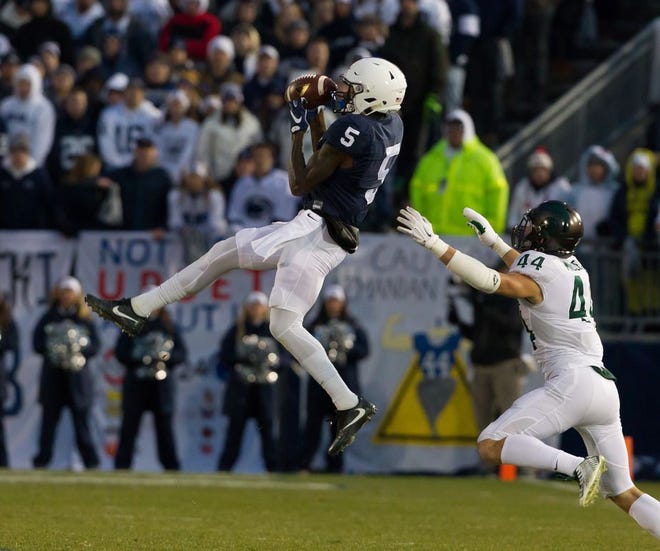 Penn State wide receiver DaeSean Hamilton (5) goes for a mid-air reception against Michigan State free safety Grayson Miller Saturday in State College.