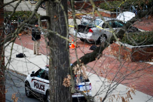 A car inside a police line sits on the sidewalk as authorities respond to an attack on campus at Ohio State University Monday in Columbus, Ohio. 
AP Photo/John Minchillo