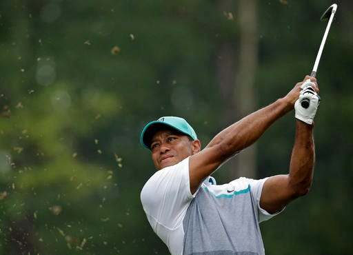 FILE - In this Aug. 20, 2015, file photo, Tiger Woods watches his shot on the 12th hole during the first round of the Wyndham Championship golf tournament in Greensboro, N.C. Tiger Woods returns to competition, and Ernie Els is more curious about his head than any of his back surgeries that kept him out 15 months. (AP Photo/Chuck Burton, File)