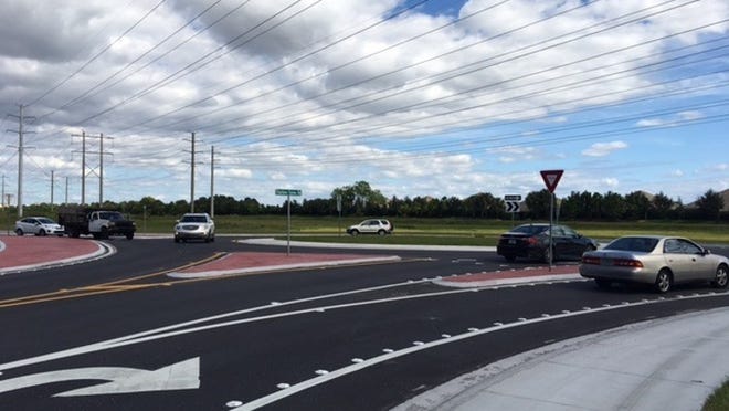 People drive their cars around the new roundabout in Wellington at Stribling Way and Fairlane Farms Road (Matt Morgan/The Palm Beach Post).