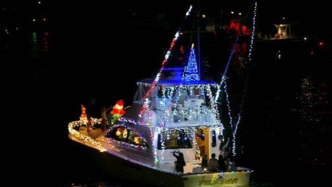 Small boats and yachts are decorated for the annual boat parade in north county (Photo/Allen Eyestone)
