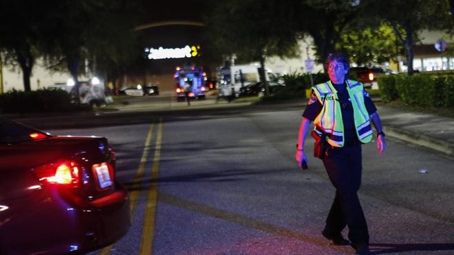 A Boynton Beach police officer blocks the entrance of a Walmart on 3200 Old Boynton Road Saturday night, November 26, 2016 in Boynton Beach. The Walmart was evacuated after reports of a gunman. The city’s SWAT team responded to the incident but didn’t find the gunman inside the store. (Yuting Jiang / The Palm Beach Post)
