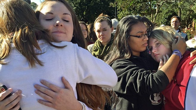 A shooting occured at Florida State University on Nov. 19, 2014 in which a former student shot three people at the university’s Strozier Library. The shooter was shot dead by police; the three people who were shot survived. It was the last reported shooting at a university in Florida and occured just over two years before Monday’s attack at Ohio State University. In this photo, students in Tallahassee comfort each other the morning after the FSU shooting. (Kathleen McGrory/Miami Herald/TNS)