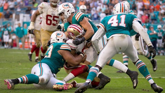 Miami Dolphins defensive tackle Ndamukong Suh (93) and Miami Dolphins middle linebacker Kiko Alonso (47) stop San Francisco 49ers quarterback Colin Kaepernick (7) at the two yard line on the final play of the game at Hard Rock Stadium in Miami Gardens, Florida on November 27, 2016. (Allen Eyestone / The Palm Beach Post)