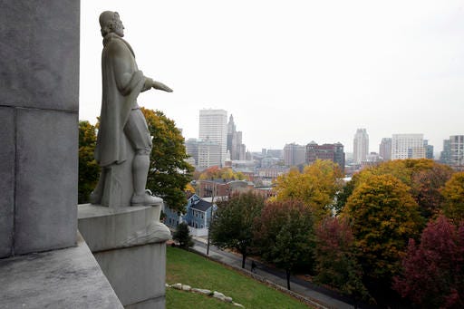 In this Thursday, Nov. 3, 2016, photo, a statue of Roger Williams over looks the skyline, in Providence.