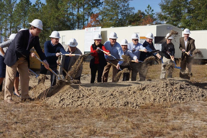 Marty Daniel (sixth from right), standing to the left of his wife Cindy, along other dignitaries break ground for Daniel Defense's new new $29.5 million Black Creek facility Monday. (Jamie Parker/Bryan County Now)