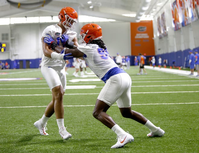 Florida defensive linemen Jordan Sherit, left, and Keivonnis Davis run a drill during a practice earlier this season. Sherit is out for Saturday's game, allowing Davis even more playing time. (Matt Stamey/Correspondent/file)