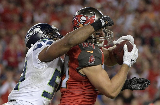 Seattle Seahawks middle linebacker Bobby Wagner (54) hits Tampa Bay Buccaneers tight end Cameron Brate (84) after a reception during the fourth quarter of an NFL game on Sunday. Phelan Ebenhack / AP