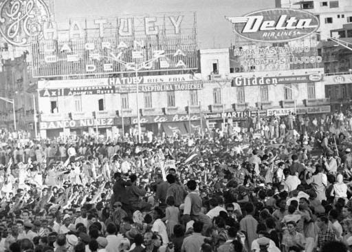 FILE - This Jan. 7, 1959 file photo shows a crowd surrounding Fidel Castro, center right, waving from a small personnel carrier in Santa Clara, Cuba, as he and his troops make their way to Havana where a provisional government had assumed power. After his band of bearded rebels won power in 1959, Castro embarked on a victory tour delivering speeches to cheering crowds stretching from the eastern Cuban city of Santiago to Havana. Starting Nov. 30, 2016, his ashes will retrace that journey in a solemn procession to his final resting spot. (AP Photo, File)