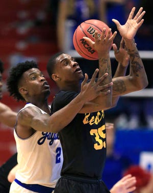 Long Beach State forward Javonntie Jackson (35) handles a pass while covered by Kansas guard Lagerald Vick (2) during the first half of an NCAA college basketball game in Lawrence, Kan., Tuesday, Nov. 29, 2016. (AP Photo/Orlin Wagner)