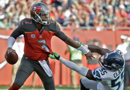 Tampa Bay Buccaneers quarterback Jameis Winston (3) pushes off Seattle Seahawks defensive end Frank Clark (55) during the first quarter of an NFL football game Sunday, Nov. 27, 2016, in Tampa, Fla. (AP Photo/Chris O'Meara)