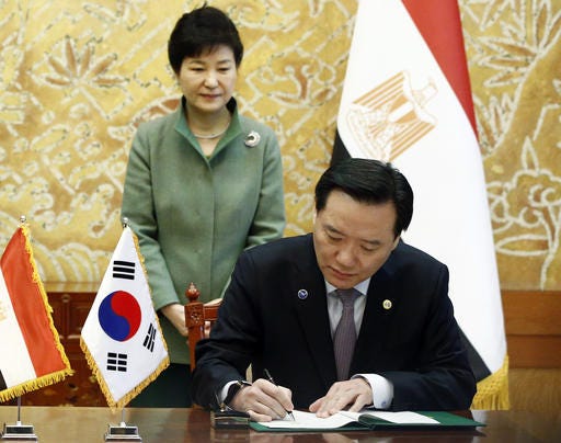 FILE - In this March 3, 2016 file, South Korean President Pak Geun-hye, left, looks at Justice Minister Kim Hyun-woong signing the agreement with Egypt's Foreign Minister Sameh Shoukry at the presidential house in Seoul. South Korea's embattled president has accepted the resignation of her justice minister, the latest in a series of personnel reshuffles she's made amid a political scandal that's threatening her leadership. (Jeon Heon-kyun/Pool Photo via AP, File)